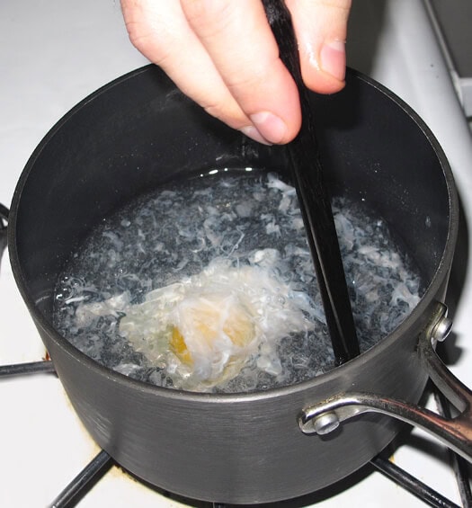 large egg poaching in water