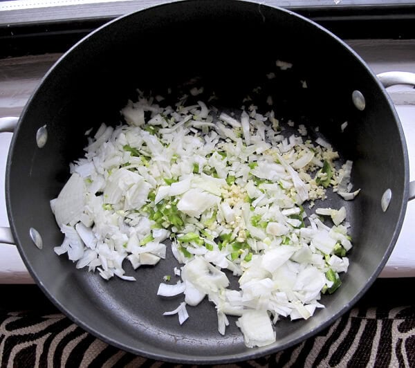 chopped onions, jalapeno, ginger and garlic chopped vegetables in cooking pot